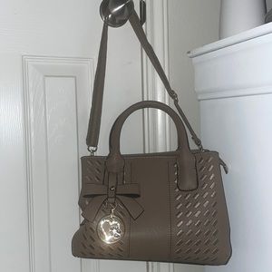 This purse is a good for everyday material. Holds a lot of stuff and pockets.